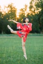 Japanese ballerina in red kimono stands in swallow pose Royalty Free Stock Photo