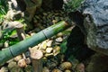 A Japanese Bamboo Water Fountain Shishi-Odoshi in Zen Garden Royalty Free Stock Photo