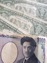 Japanese banknote of 1000 yen and American one dollar bills Royalty Free Stock Photo