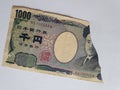 Japanese banknote of 1000 yen on the broken sheet of paper Royalty Free Stock Photo