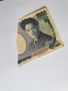 Japanese banknote of 1000 yen on the broken sheet of paper Royalty Free Stock Photo