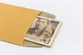 Japanese banknote 10,000 yen in brown envelope for give and business success and shopping. Royalty Free Stock Photo