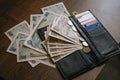 Japanese banknotes and coins scattered on the wooden table near the wallet. Royalty Free Stock Photo