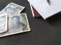 japanese banknotes of 1000 yen, books and pen