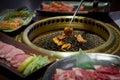 Japanese Barbecue on a Hot Chacoal Stove. Chicken grilling on griddle pan Royalty Free Stock Photo