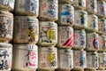 Japanese Barrels of Sake wrapped in Straw stacked on shelf