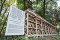 Japanese Barrels of Wine wrapped in Straw stacked on shelf with description board