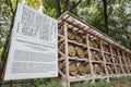 Japanese Barrels of Wine wrapped in Straw stacked on shelf with description board