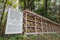 Japanese Barrels of Wine wrapped in Straw stacked on shelf with description board