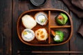 Japanese bento lunch box with chopsticks, on old dark  wooden table background, top view flat lay Royalty Free Stock Photo