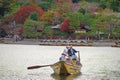 Japanese boatman sail boat to enjoy autumn leave