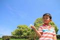 Japanese boy blowing dandelion seeds Royalty Free Stock Photo