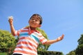 Japanese boy blowing dandelion seeds Royalty Free Stock Photo