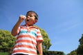 Japanese boy blowing dandelion seeds Royalty Free Stock Photo