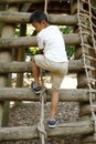 Japanese boy climbing on the wall Royalty Free Stock Photo