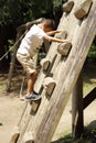Japanese boy climbing on the wall Royalty Free Stock Photo