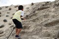 Japanese boy climbing on the wall Royalty Free Stock Photo