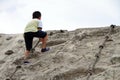 Japanese boy climbing on the wall Royalty Free Stock Photo