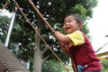 Japanese boy climbing on the wall Royalty Free Stock Photo