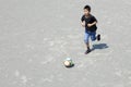 Japanese boy dribbling soccer ball Royalty Free Stock Photo