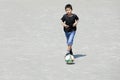 Japanese boy dribbling soccer ball Royalty Free Stock Photo