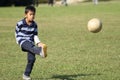 Japanese boy playing with soccer ball Royalty Free Stock Photo