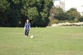 Japanese boy playing with soccer ball Royalty Free Stock Photo