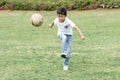 Japanese boy playing with soccer ball Royalty Free Stock Photo