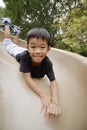 Japanese boy on the slide Royalty Free Stock Photo