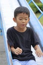 Japanese boy on the slide Royalty Free Stock Photo