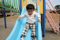 Japanese boy on the slide Royalty Free Stock Photo