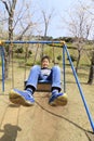 Japanese boy on the swing Royalty Free Stock Photo