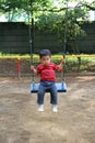 Japanese boy on the swing Royalty Free Stock Photo