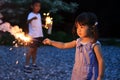 Japanese brother and sister doing handheld fireworks Royalty Free Stock Photo
