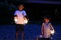 Japanese brother and sister doing handheld fireworks Royalty Free Stock Photo