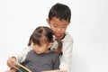 Japanese brother and sister reading a picture book Royalty Free Stock Photo