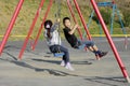 Japanese brother and sister on the swing Royalty Free Stock Photo