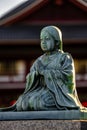 Japanese Buddhist temple in Tokyo, Japan, featuring a statue of a woman in prayer. Royalty Free Stock Photo