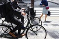 Japanese business men on bicycles on the sidewalk in Tokyo Royalty Free Stock Photo