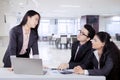 Japanese business woman talking to her colleagues