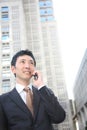 Japanese businessman talks with a mobile phone Royalty Free Stock Photo