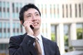 Japanese businessman talks with a mobile phone Royalty Free Stock Photo