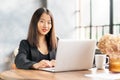 Japanese businesswoman work in laptop in cafe. Royalty Free Stock Photo