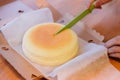 Japanese Cheesecake cut by green knife in opened paper box. Soft and sweet Royalty Free Stock Photo