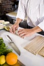 Japanese chef in restaurant making sushi roll