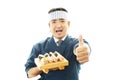 Japanese chef showing thumbs up sign