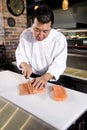 Japanese chef slicing raw fish for sushi Royalty Free Stock Photo