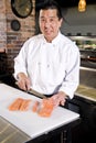 Japanese chef slicing raw fish for sushi