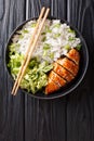 Japanese chicken teriyaki with rice and fresh salad close-up on a plate. Vertical top view Royalty Free Stock Photo