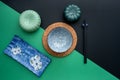 Japanese or Chinese table setting with traditional table mat and dinnerware with green and black background. Royalty Free Stock Photo
